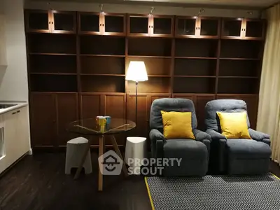 Cozy living room with plush recliners and elegant wooden shelving