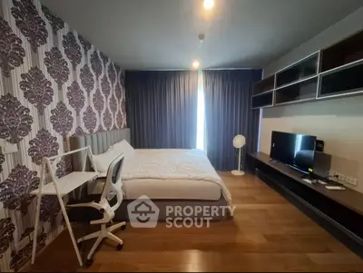 Modern bedroom with stylish wallpaper and cozy furnishings