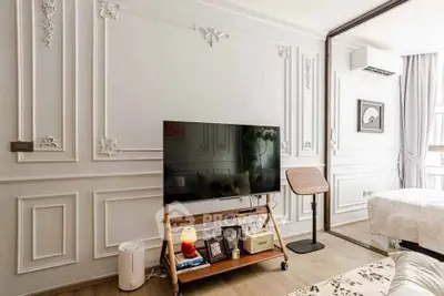 Elegant living room with classic wall moldings and modern TV setup