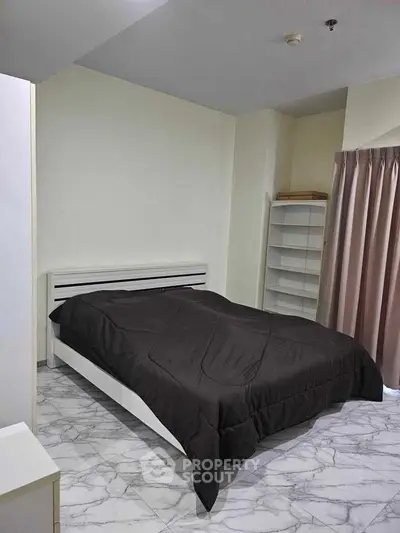 Modern bedroom with sleek design and marble flooring, featuring a cozy bed and ample natural light.