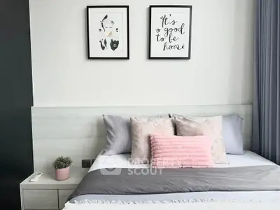 Cozy bedroom with stylish decor and soft pastel accents, perfect for relaxation and comfort.