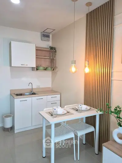Modern kitchen with sleek white cabinets and cozy dining area