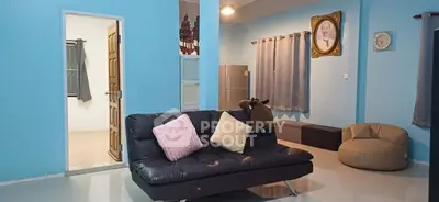 Spacious living room with modern decor and cozy seating in a stylish home.