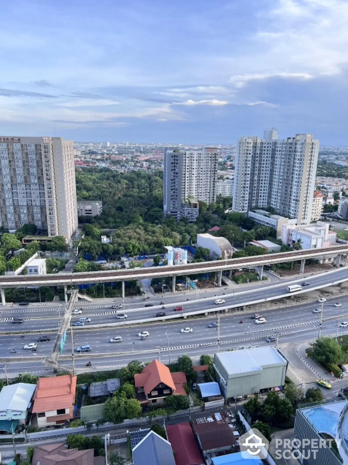 Stunning cityscape view with high-rise buildings and lush greenery, perfect for urban living enthusiasts.