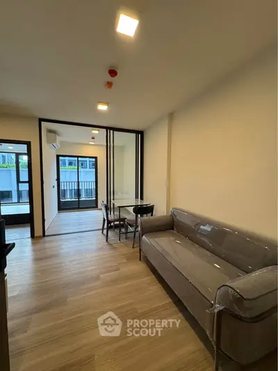 Modern living room with wooden flooring and stylish furniture in a contemporary apartment.