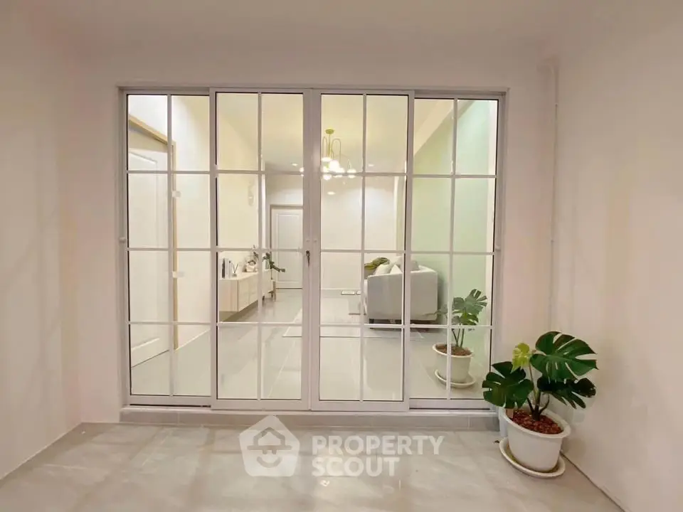 Elegant living room with glass doors and stylish decor