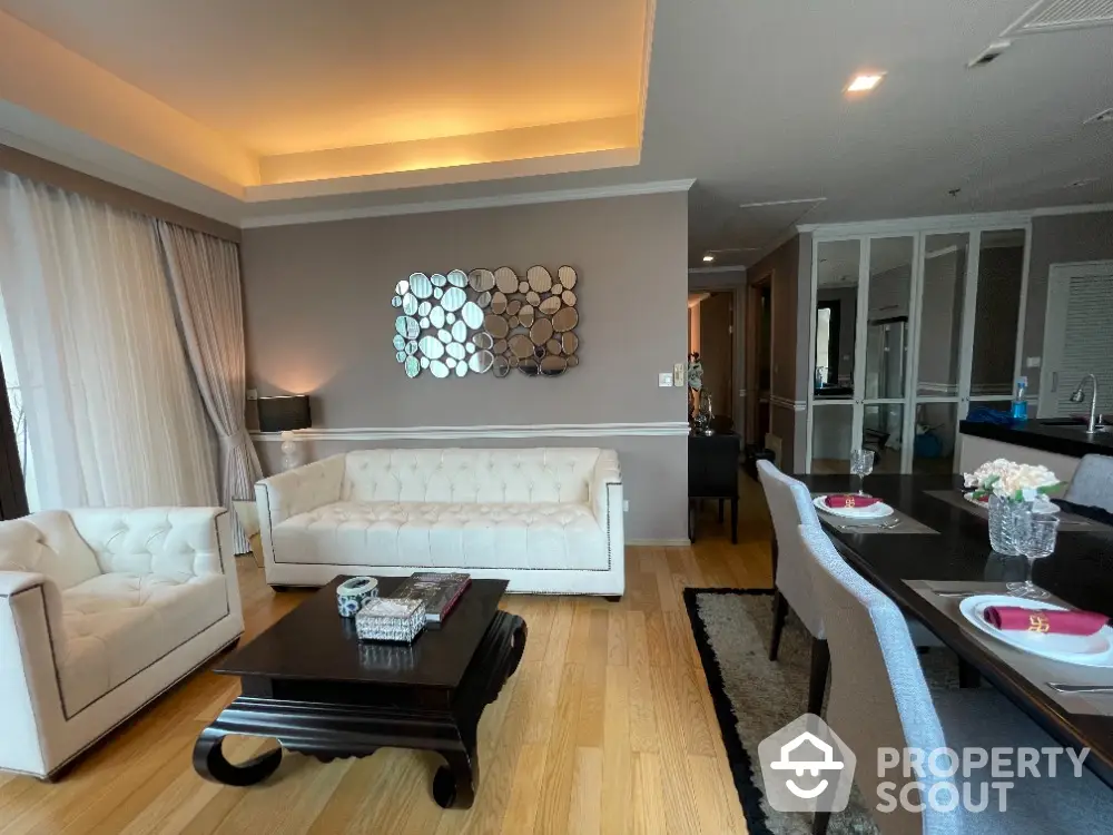 Elegant living room with modern decor and dining area, featuring stylish furniture and ambient lighting.