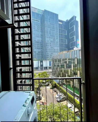 Urban apartment balcony with city view and washing machine
