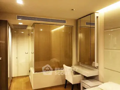 Modern bedroom with elegant design featuring a cozy chair and built-in vanity mirror.