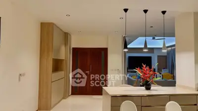 Modern kitchen with sleek cabinetry and stylish lighting in a contemporary home.
