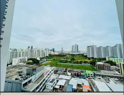 Stunning cityscape view from high-rise building balcony, showcasing urban skyline and greenery.
