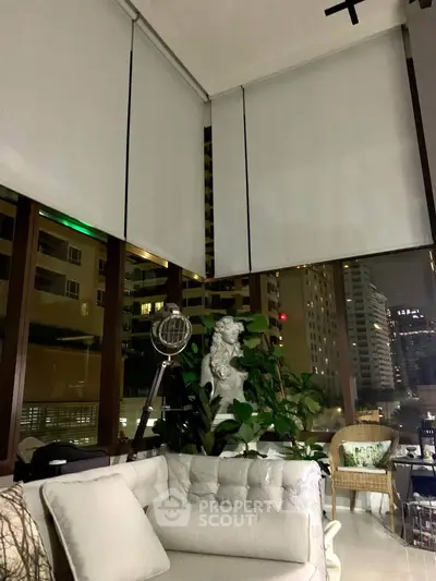 Luxurious modern living room with floor-to-ceiling windows and city view, featuring elegant decor and cozy seating.