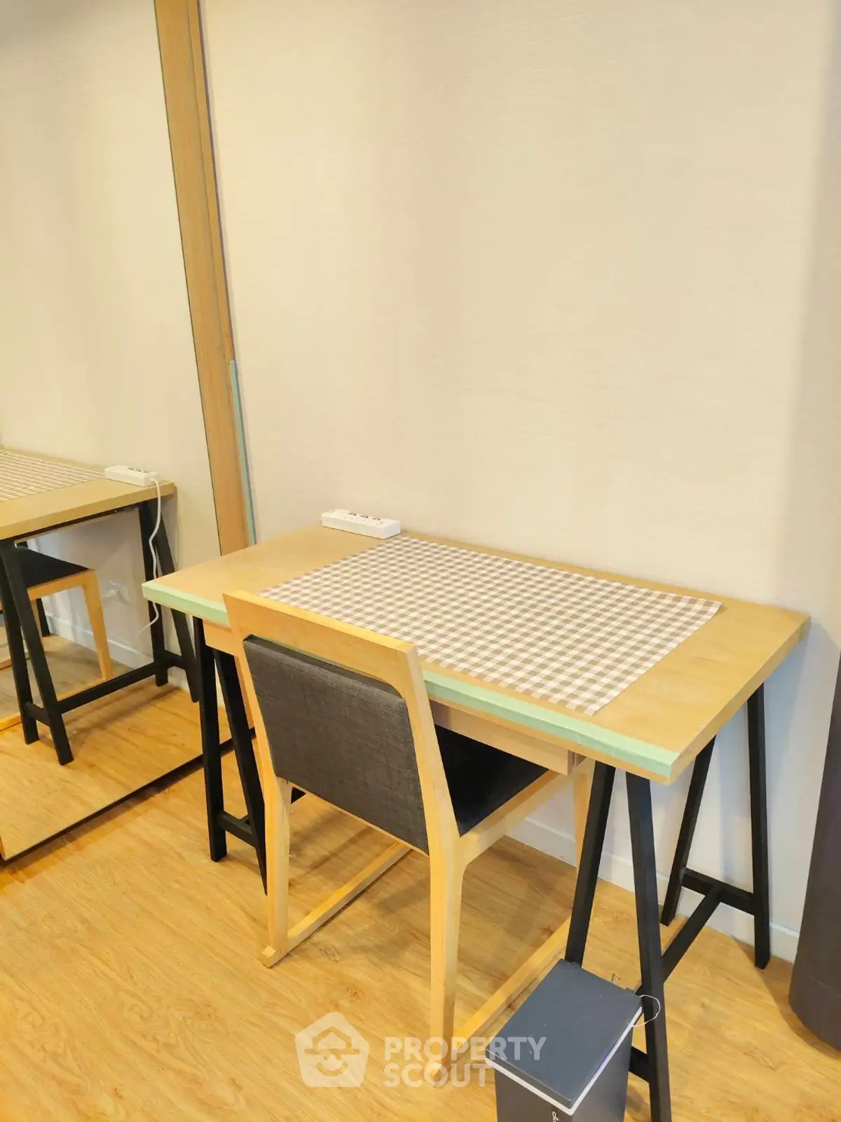 Modern study area with wooden desk and chair, perfect for productivity.