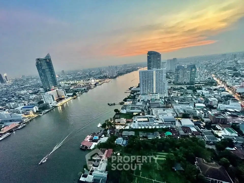 Stunning aerial view of a vibrant cityscape with river and skyscrapers at sunset, perfect for urban living enthusiasts.