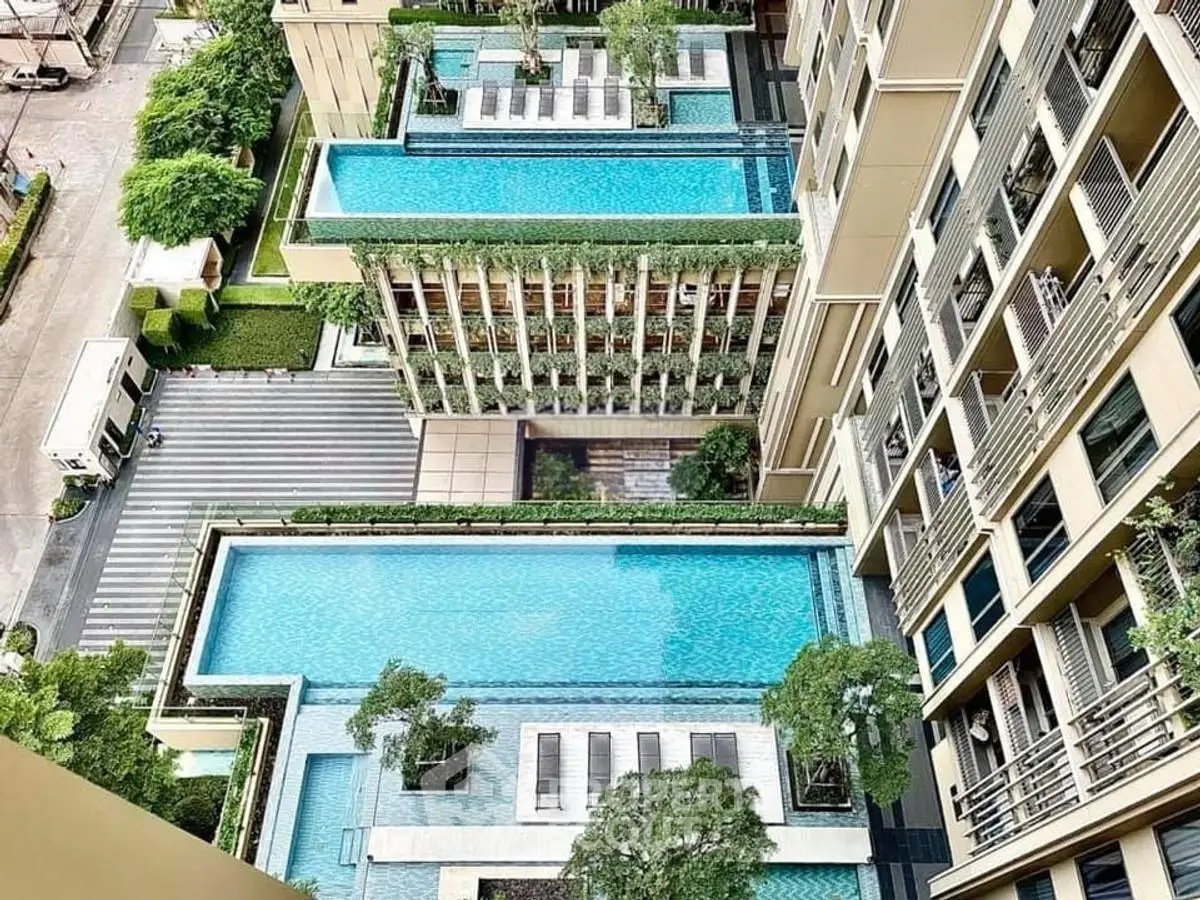 Luxurious high-rise building with multiple rooftop pools and lush greenery.