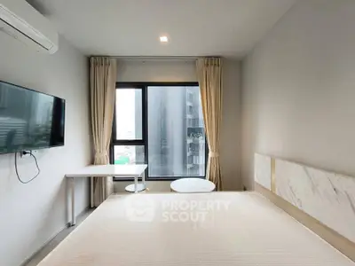 Modern bedroom with large window and minimalist decor in urban apartment