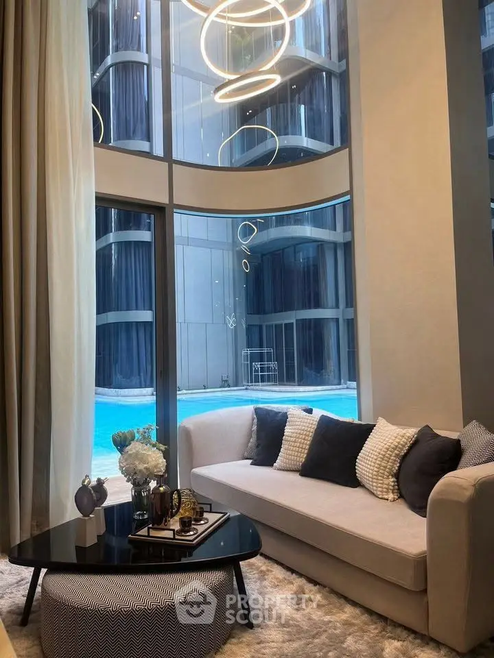Luxurious living room with pool view and modern decor in high-rise building