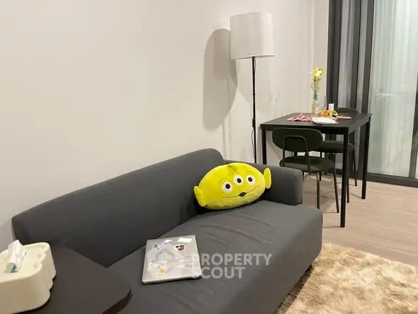 Modern living room with cozy sofa and dining area, perfect for urban living.