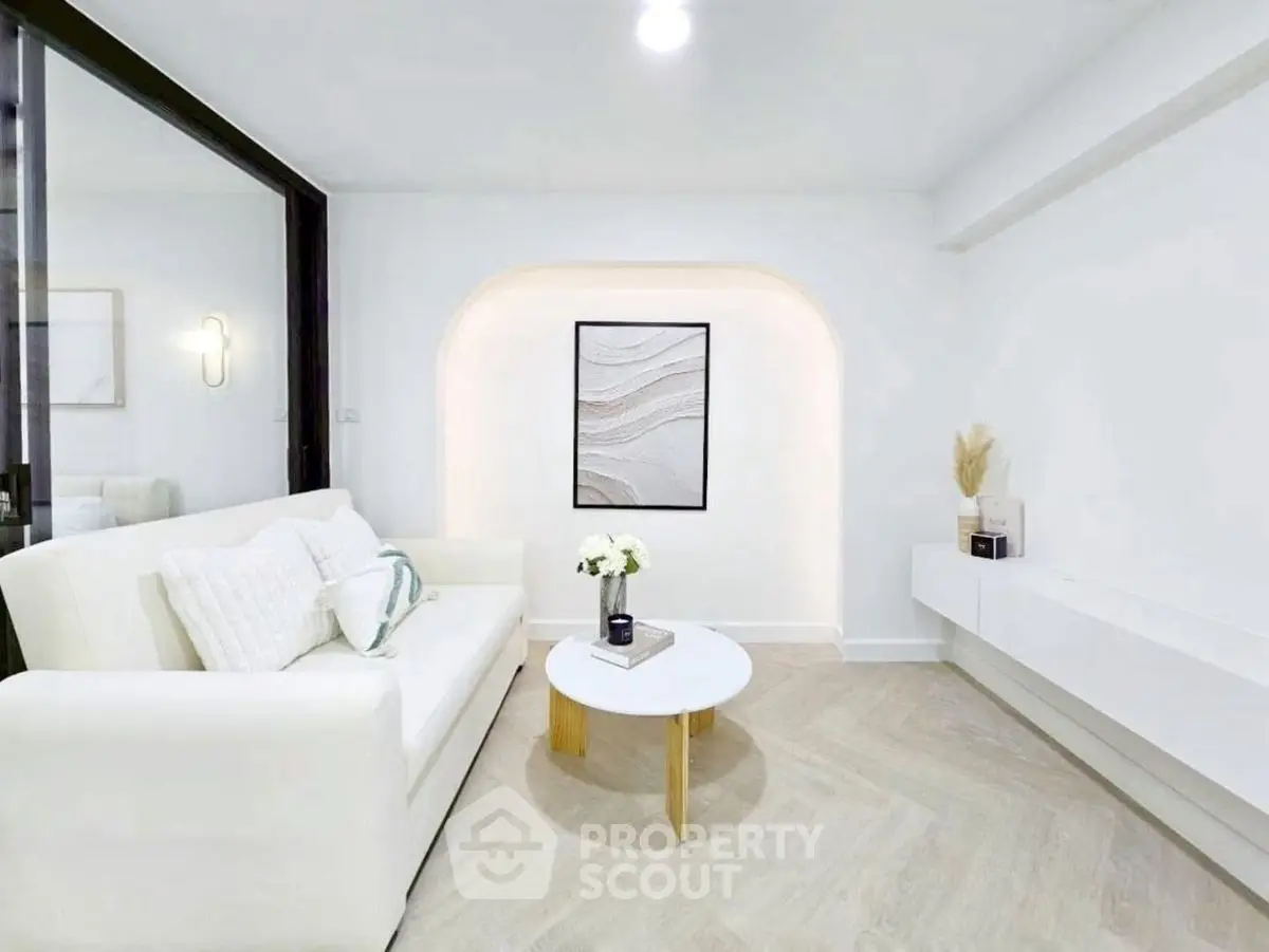 Elegant modern living room with white sofa and minimalist decor