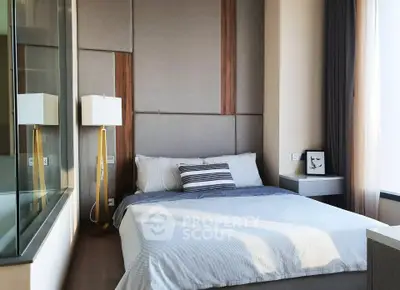 Modern bedroom with stylish decor and large window for natural light.