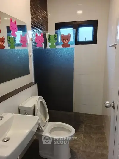 Charming bathroom with playful animal-themed decor and modern fixtures.