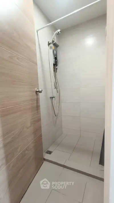 Modern bathroom with sleek shower design and neutral tile accents