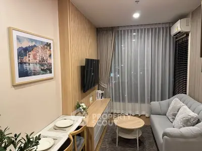 Modern living room with cozy sofa, wall-mounted TV, and elegant decor in a stylish apartment.
