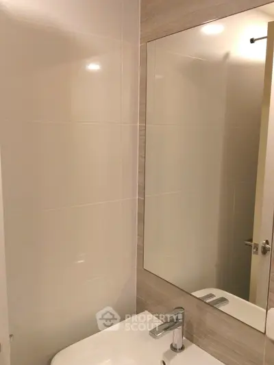 Modern bathroom with sleek sink and large mirror