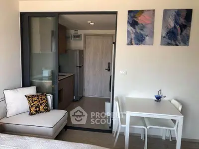 Modern studio apartment with cozy living area and compact kitchen