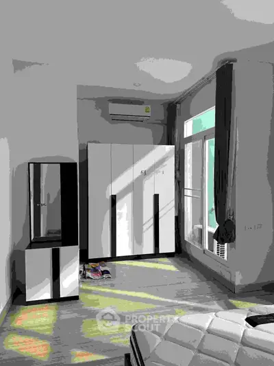 Spacious bedroom with modern wardrobe and large window for natural light.