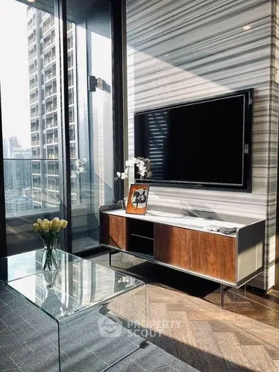 Luxurious modern living room with floor-to-ceiling windows and sleek TV setup.