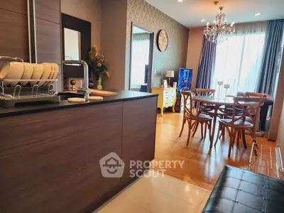 Stylish open-plan kitchen and dining area with elegant decor and natural light.