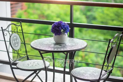 Charming balcony with elegant table set and lush green view