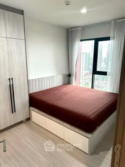 Modern bedroom with city view and sleek storage solutions