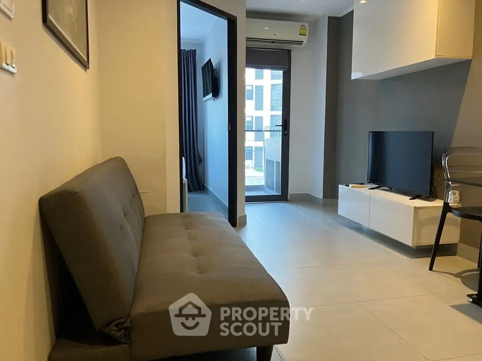 Modern living room with sleek furniture and natural light, perfect for urban living.