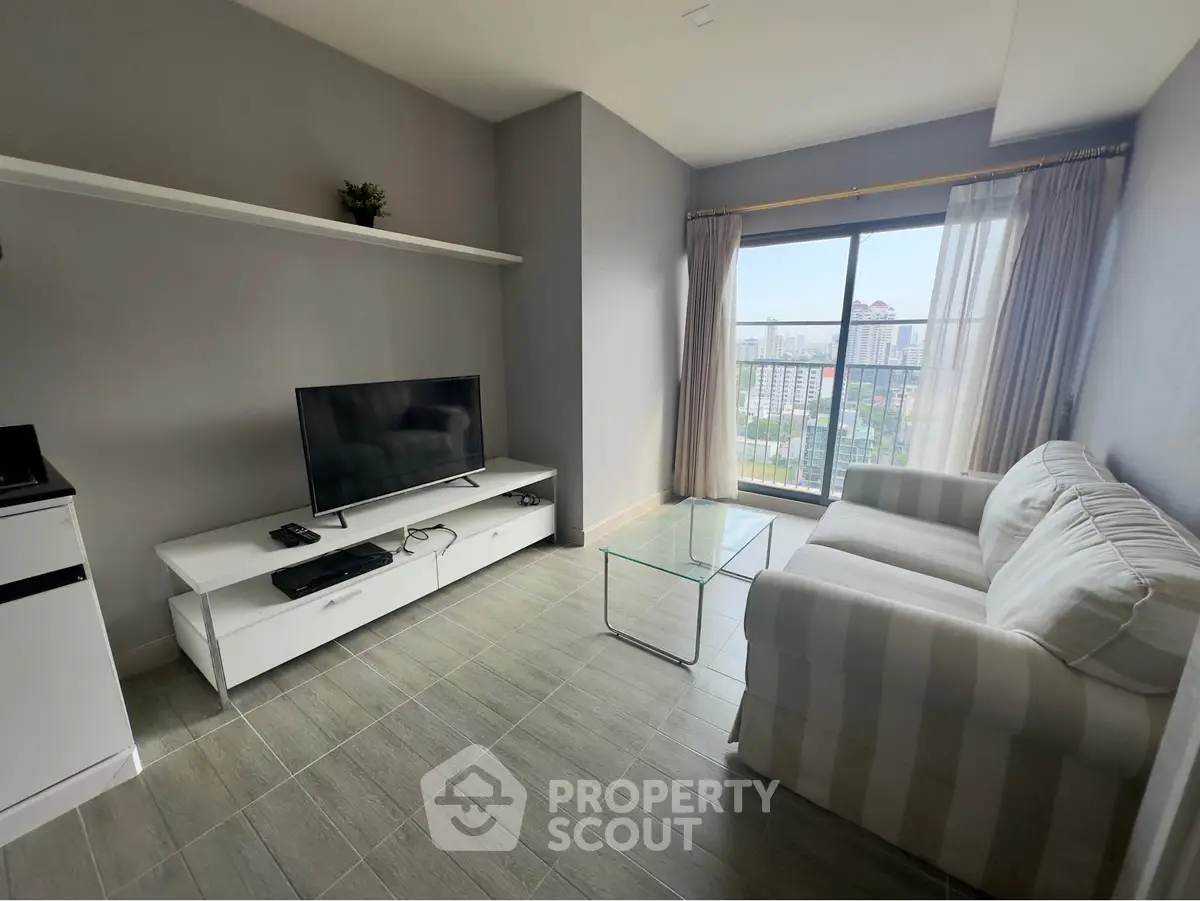 Modern living room with sleek TV setup and balcony view