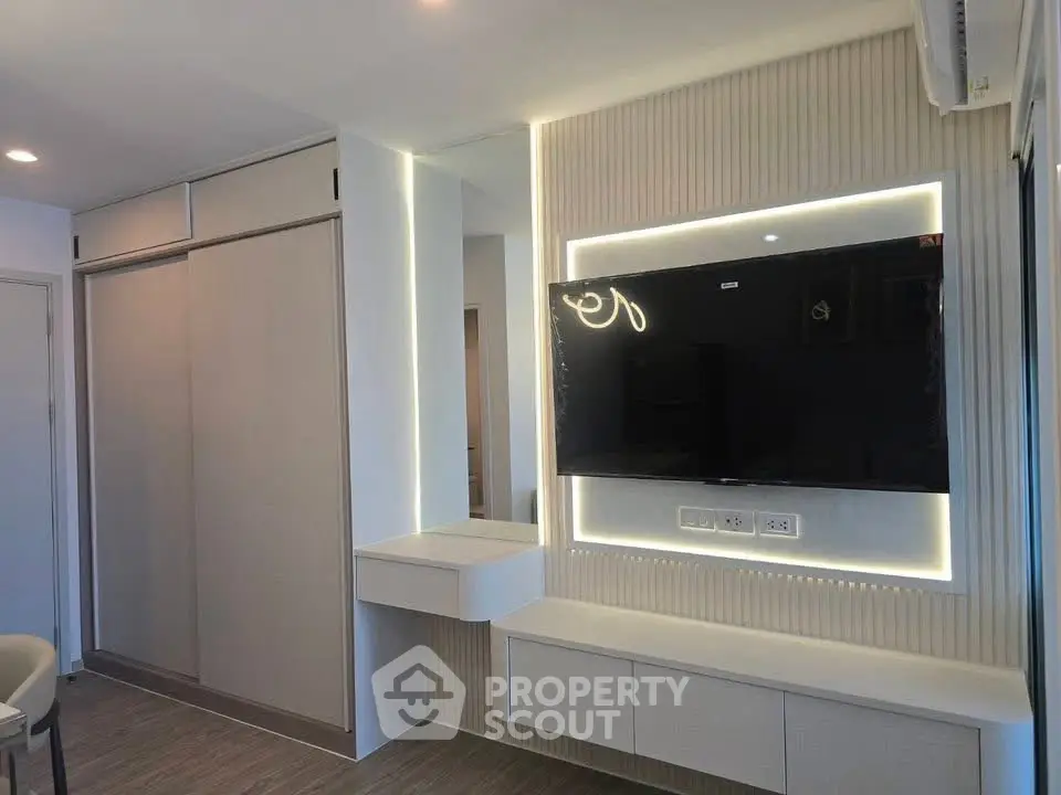 Modern living room with sleek TV setup and stylish lighting