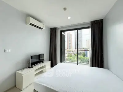 Modern bedroom with balcony view in urban high-rise apartment