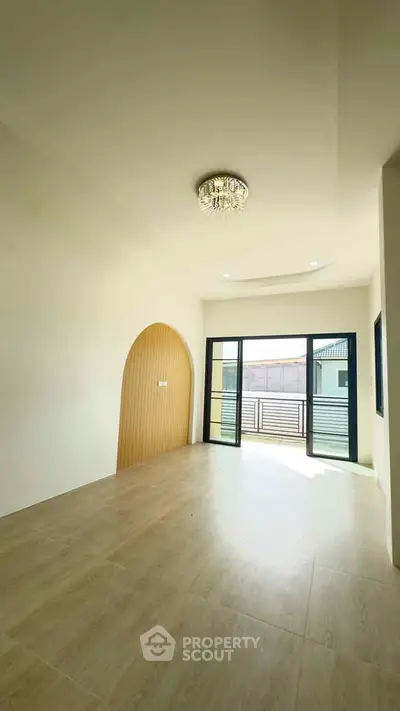 Spacious modern room with elegant lighting and large windows for natural light.