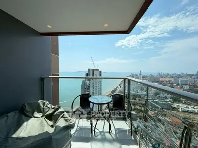 Stunning high-rise balcony with panoramic ocean and city views, perfect for relaxation and enjoying the skyline.