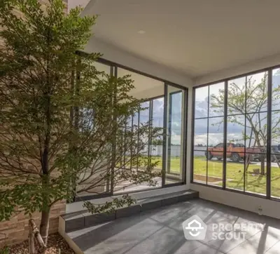 Modern home with floor-to-ceiling windows and scenic outdoor view