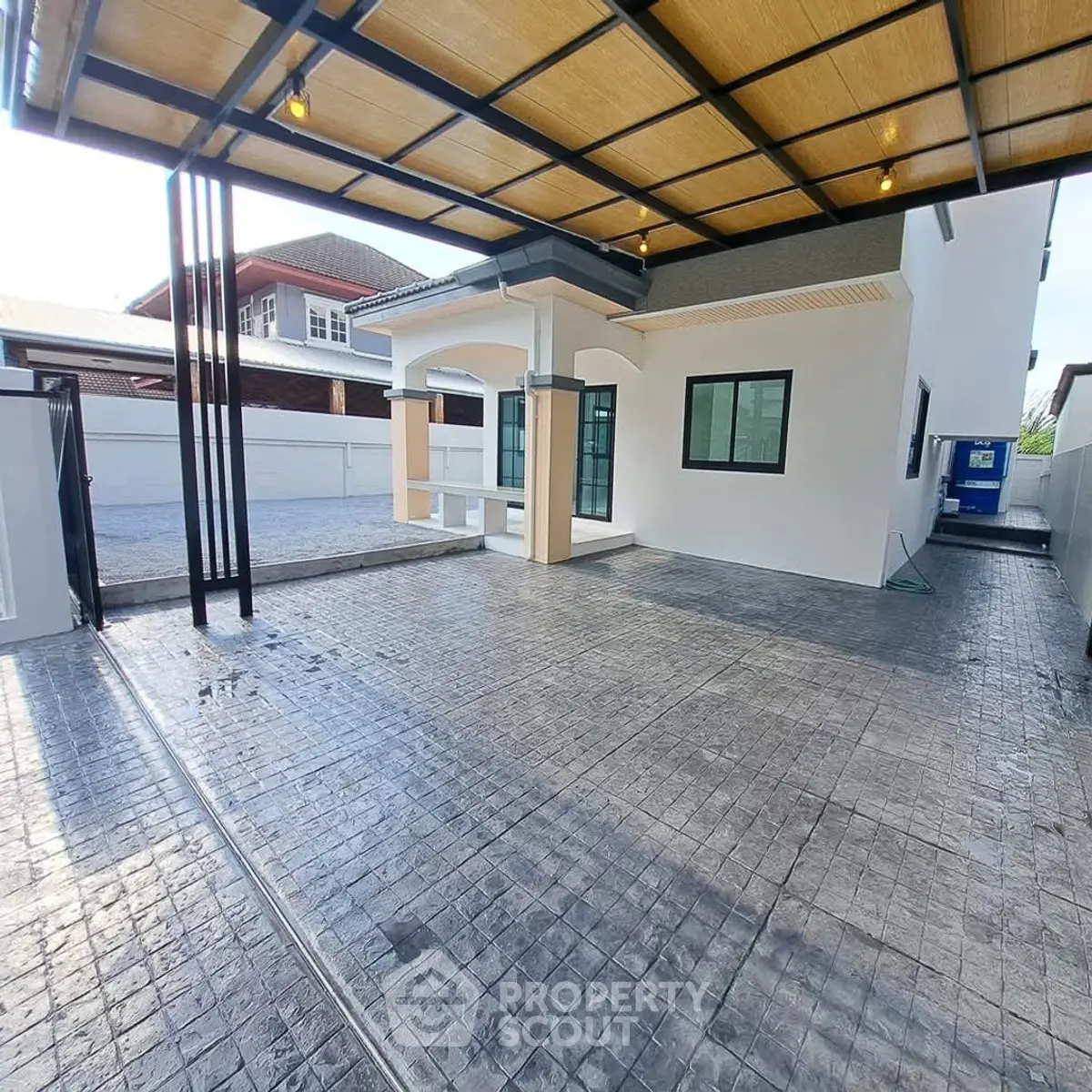 Modern house exterior with spacious driveway and stylish roof design.