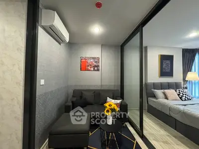 Modern living room with cozy sofa and stylish bedroom view in open layout apartment.