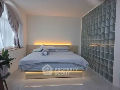 Modern bedroom with stylish glass block wall and ambient lighting