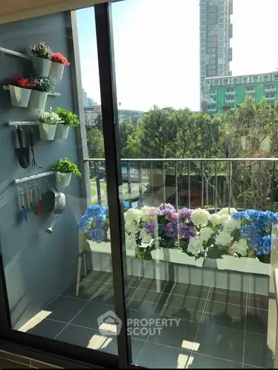 Charming balcony with vibrant flowers and city view, perfect for relaxation and enjoying urban greenery.
