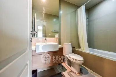 Modern bathroom with sleek fixtures and bathtub in a contemporary apartment.