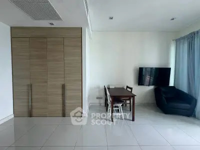 Modern living room with sleek furniture and wall-mounted TV, perfect for cozy gatherings.