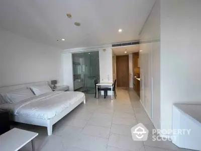 Spacious modern studio apartment with sleek design and open layout, featuring a cozy bedroom and stylish kitchen.