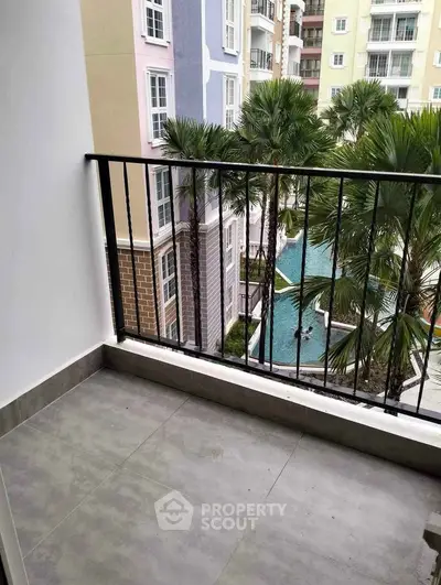 Charming balcony with pool view in modern apartment complex