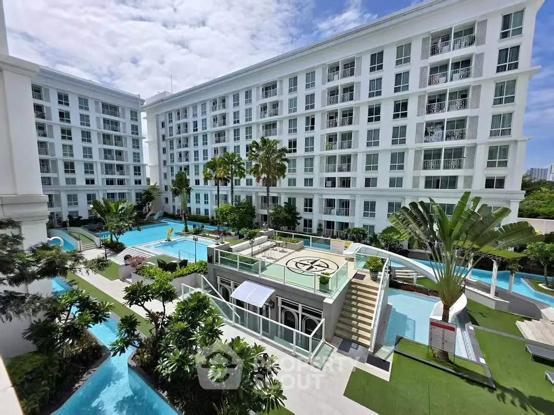 Luxurious apartment complex with stunning pool and lush greenery